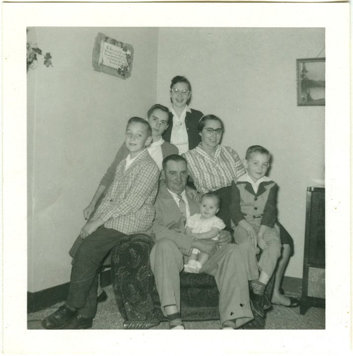 1321B.jpg - The Dan & Rachel Stutzman Family, 1961c.  Dan sitting holding Miriam, Ellis on right, Jerry on left, Erna, upper left, Rachel, right, Marcia back.